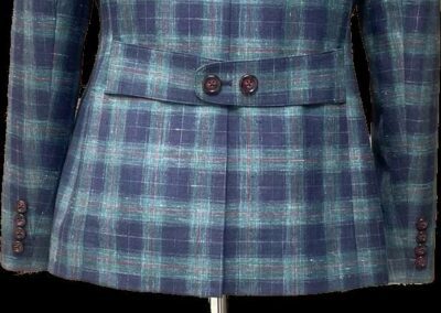 A blue and white plaid suit jacket hanging, showcasing its pattern, in Chicago, IL