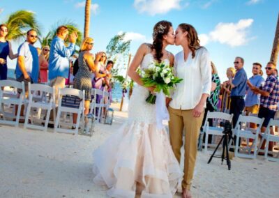 A romantic kiss between a bride and groom on a beach in Chicago, IL